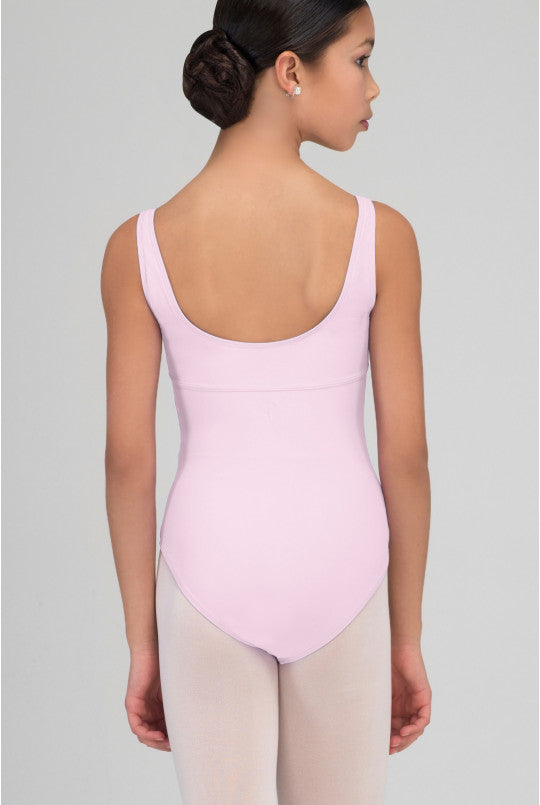 Person wearing a pink leotard on a plain background