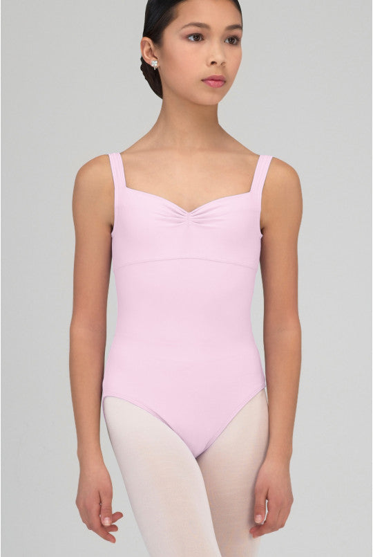 Person wearing a pink leotard on a gray background