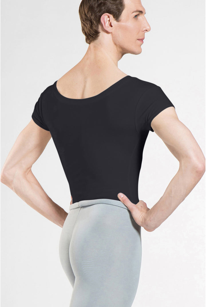 A man wearing a black short-sleeve leotard from the back, paired with light gray leggings, against a plain light gray studio background.