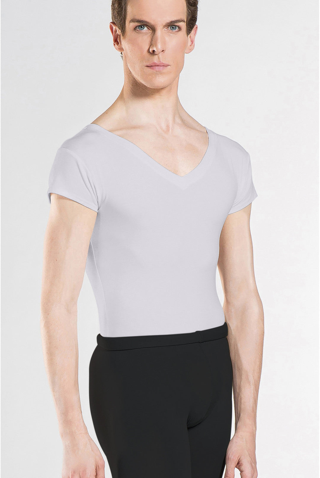 Person wearing a light gray short-sleeve top and black pants on a white background