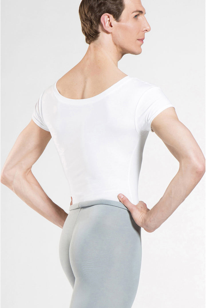 Person wearing a white t-shirt and light gray leggings on a plain background