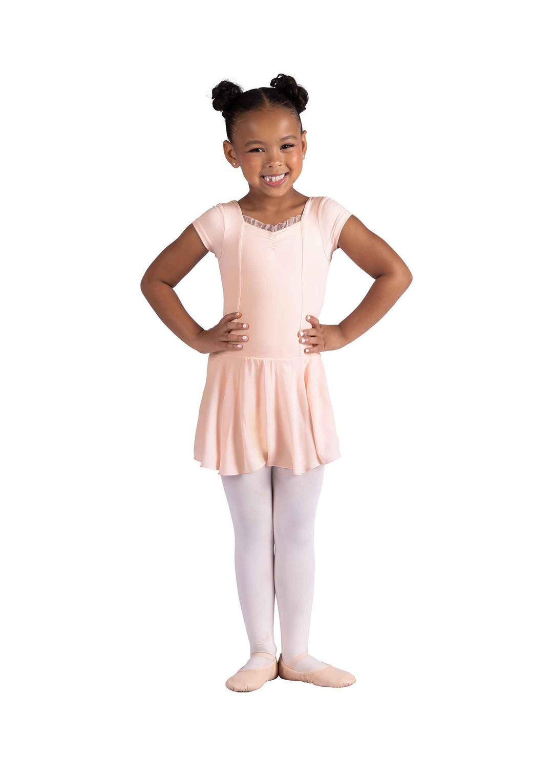 Young girl in a pink ballet dress and white tights on a white background