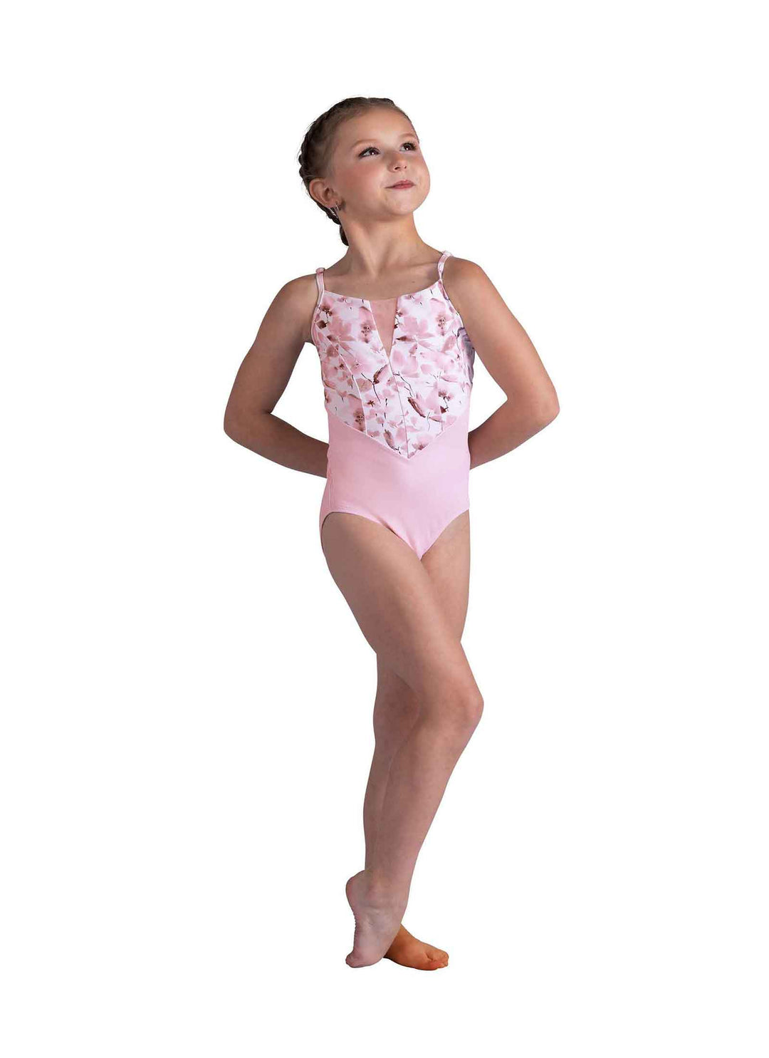 Young girl in a pink floral leotard on a white background