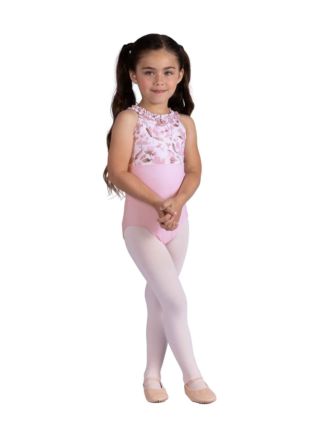 Young girl wearing a pink leotard with floral details on a white background
