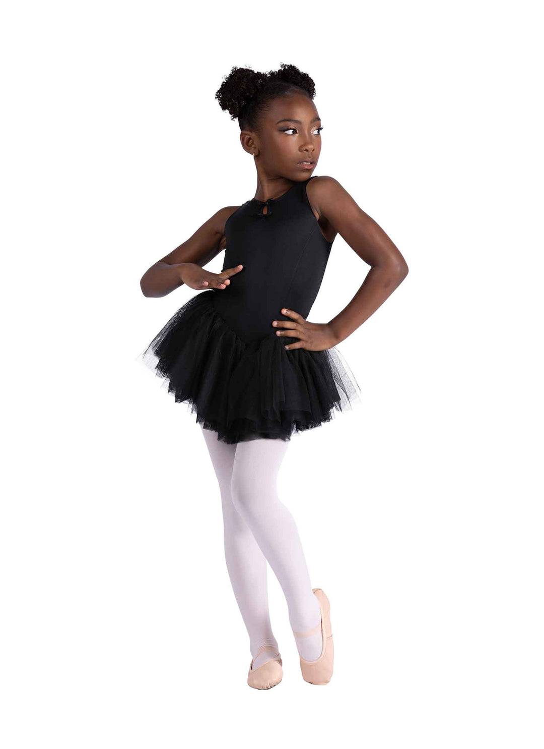 Young girl in a black ballet tutu and white tights on a white background
