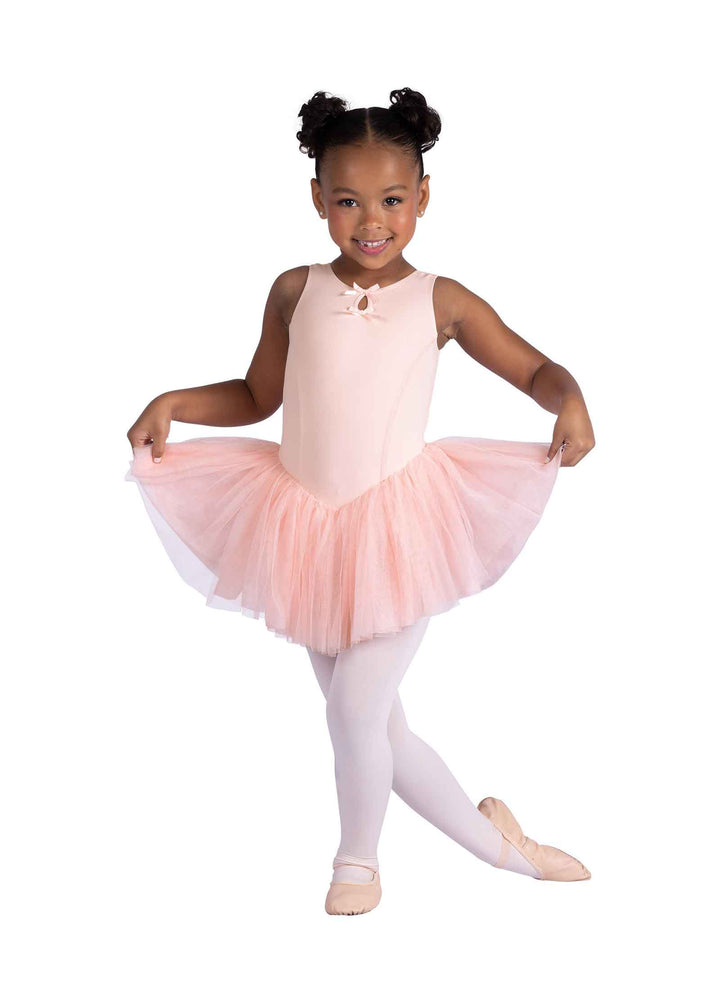 Young girl in a pink ballet outfit with a tutu on a white background