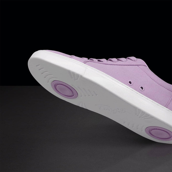 Purple sneaker with white sole on a black background