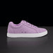 Purple sneaker with white sole on a black background