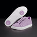 Purple sneakers with white soles on a black background