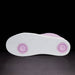 White sneaker with pink accents on a black background
