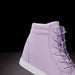 Purple high-top sneaker with white sole on a black background