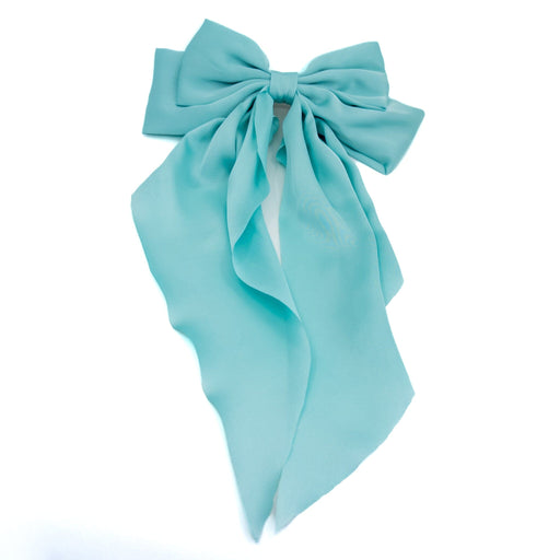 Light blue bow hair accessory on a white background