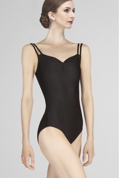 Woman wearing a black bodysuit against a plain background