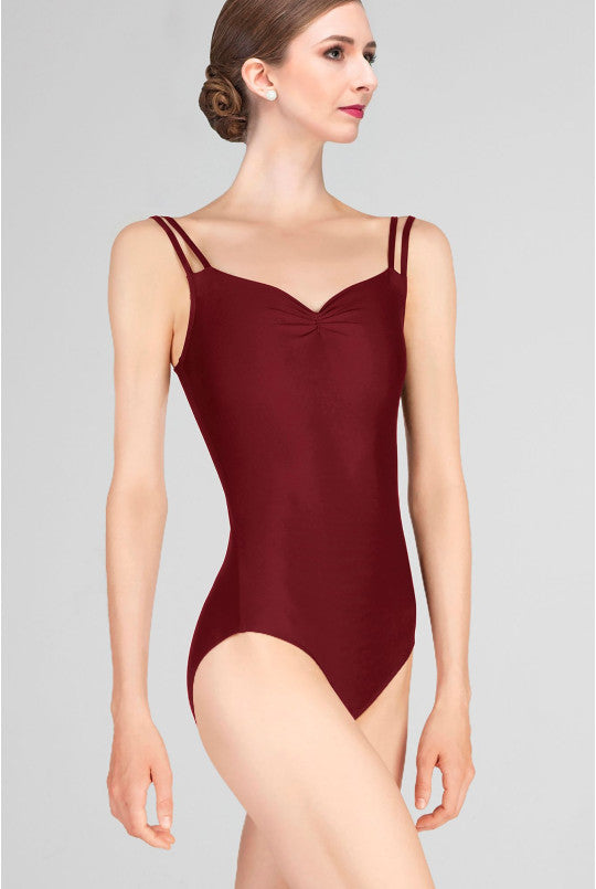 Burgundy leotard worn by a model on a gray background