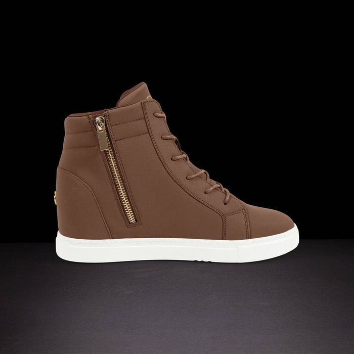 Brown high-top sneaker with a gold zipper on a black background