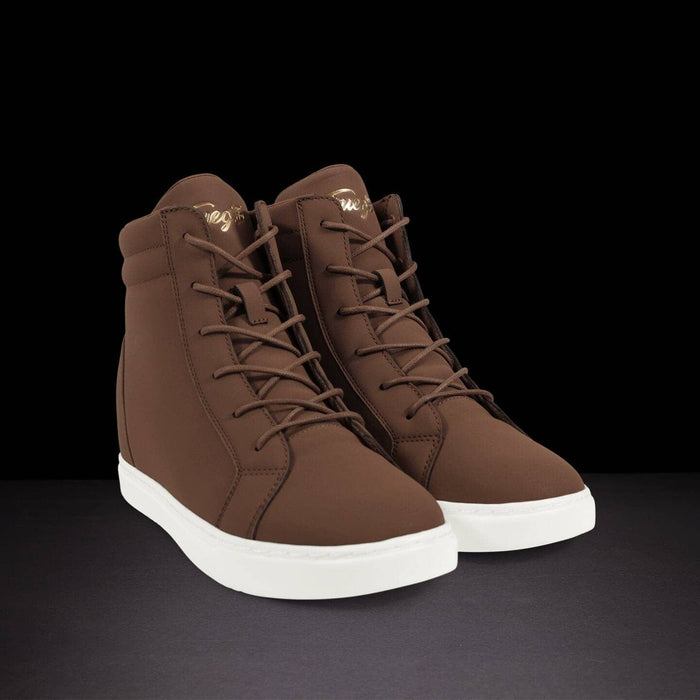 Pair of brown high-top sneakers with white soles on a black background