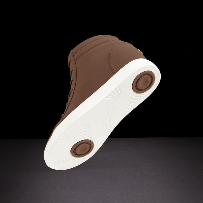 Brown sneaker with white sole on a black background
