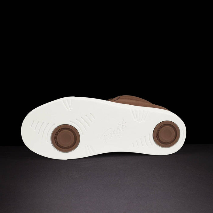 Close-up of a shoe sole with brown accents on a dark background