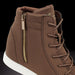 Brown high-top sneaker with gold zipper on a black background
