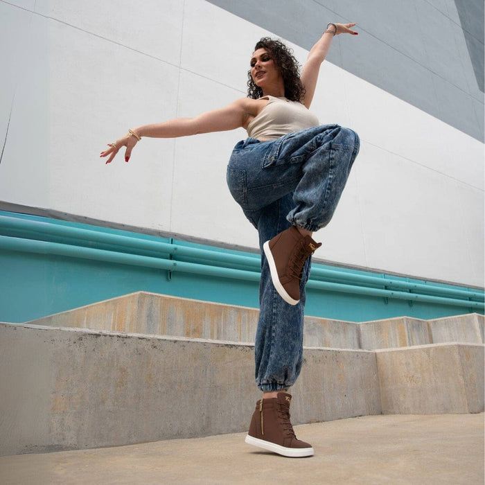 Person dancing outdoors with a modern architectural background