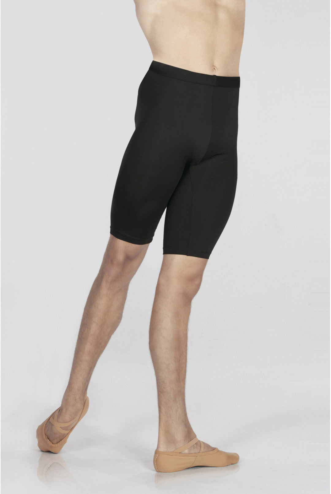 Person wearing black compression shorts on a white background