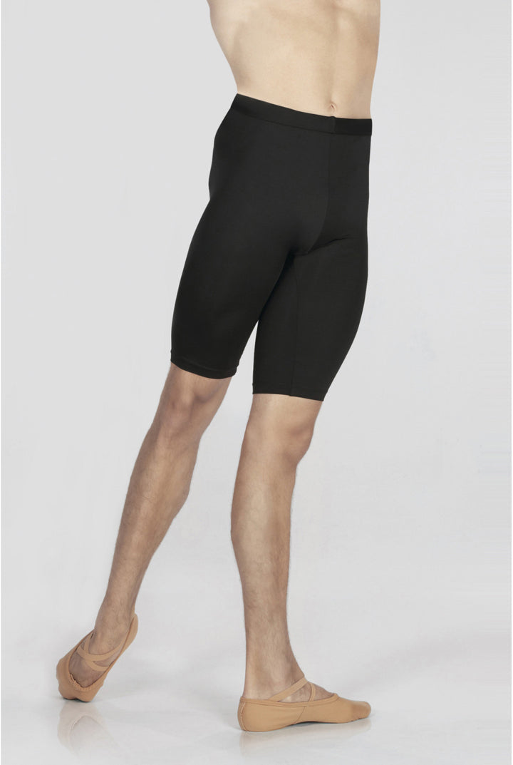 Person wearing black compression shorts on a white background