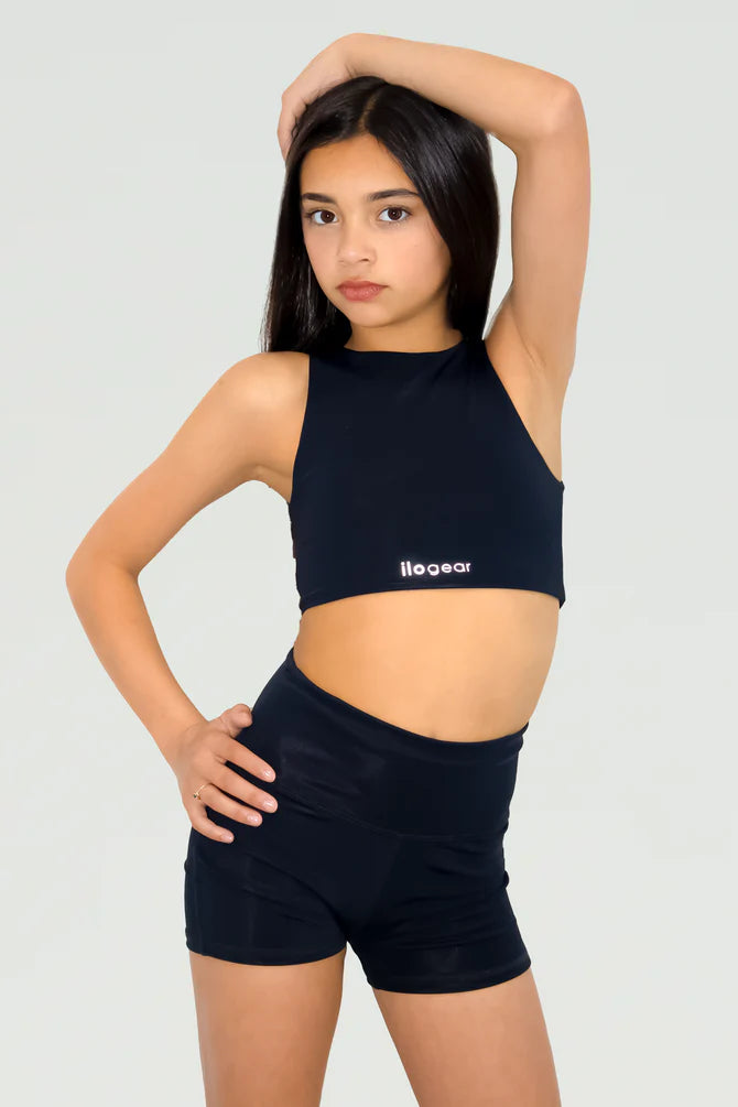Person wearing a black sports bra and shorts with 'illogear' branding on a light gray background