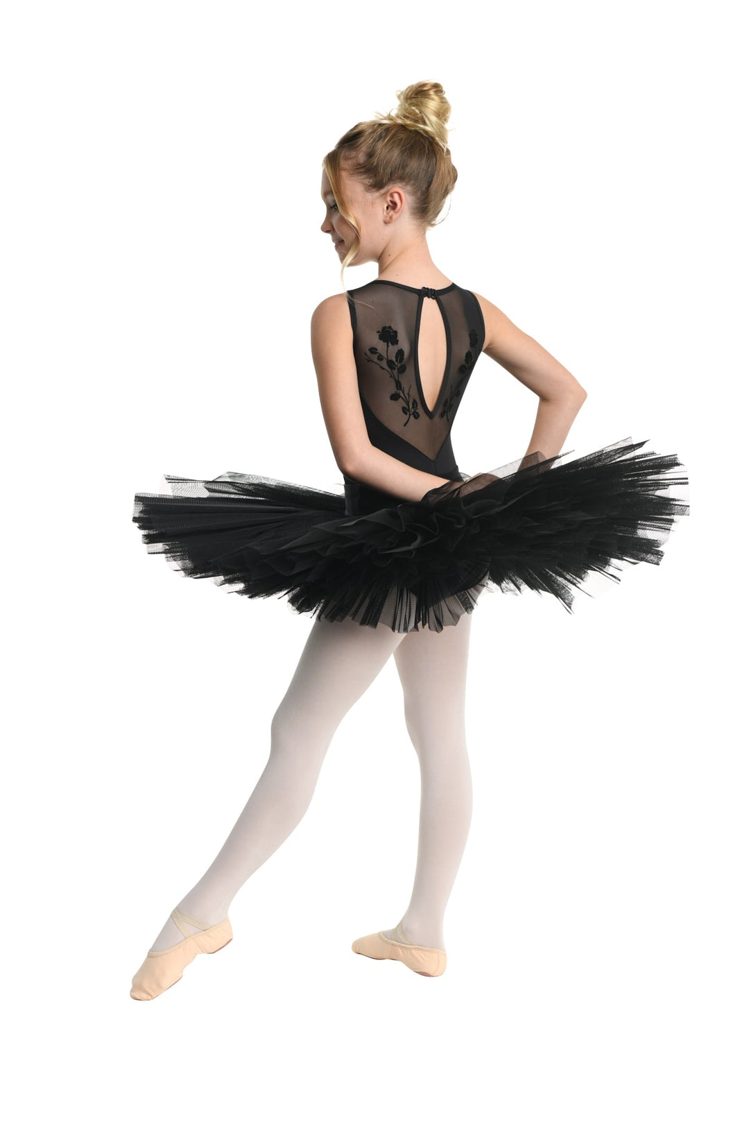 Ballerina in a black tutu and leotard on a white background