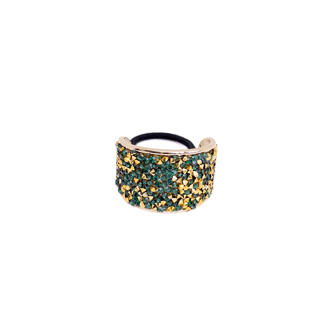 Gold and green beaded ring on a white background