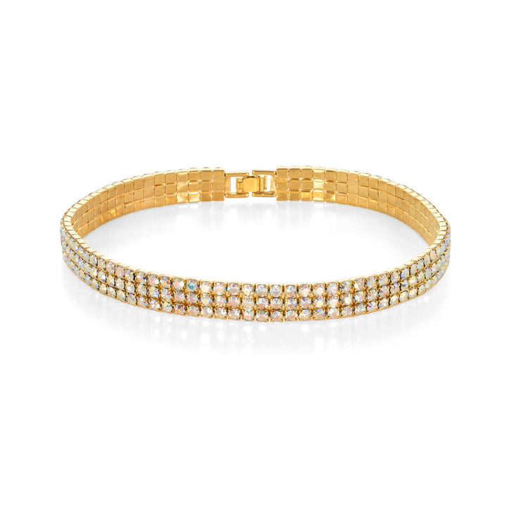 Gold choker necklace with gemstones on a white background