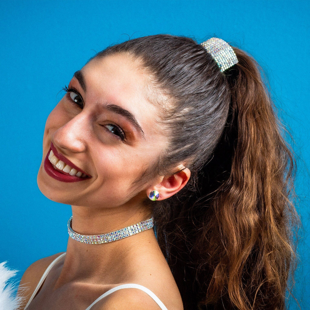 Woman with a ponytail and decorative headband against a blue background
