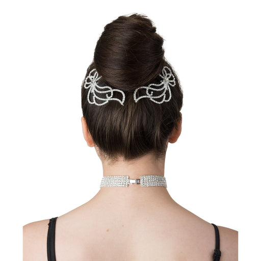 Woman wearing a decorative hairpiece and choker on a white background