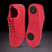 Red sneakers with black sole on a dark background