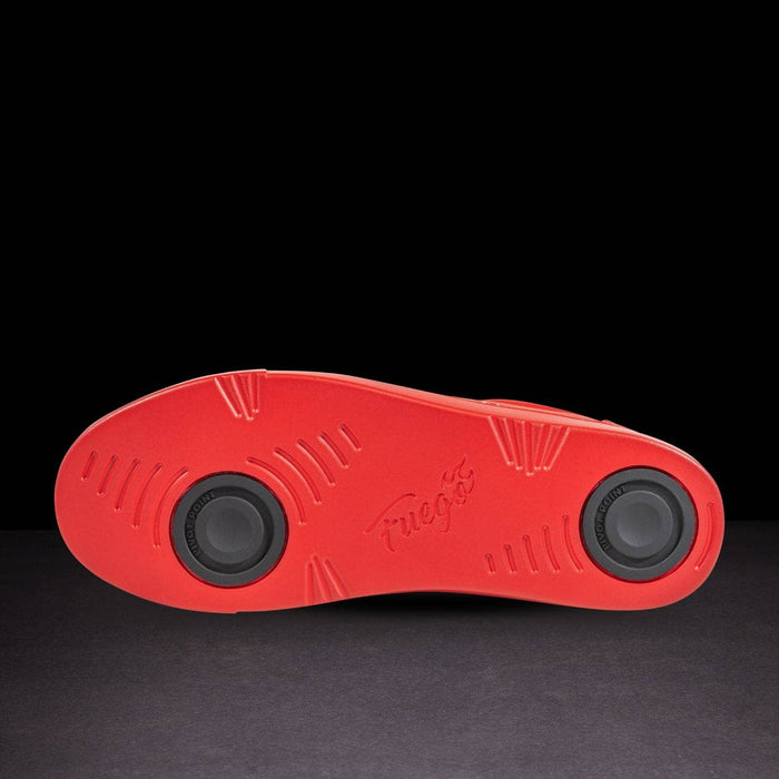 Red sole of a shoe with a brand logo on a black background