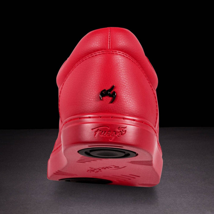 Red sneaker with a visible brand logo on a dark background