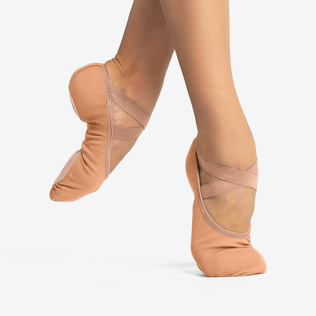 Ballet shoes with foot straps on a white background