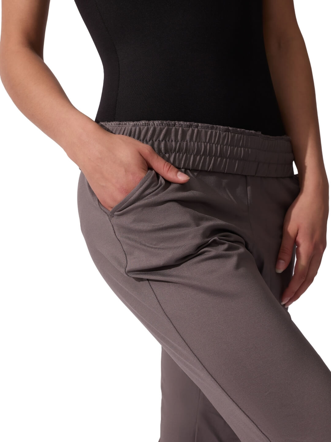 Gray pants worn by a person on a white background