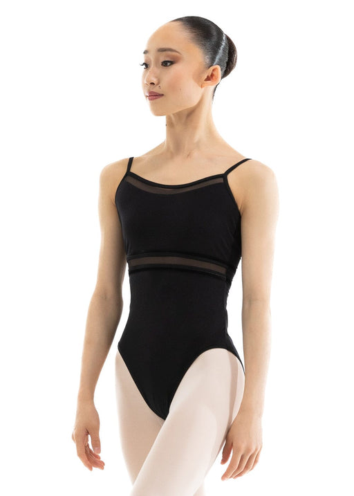 Ballerina wearing a black leotard with mesh panels on a white background